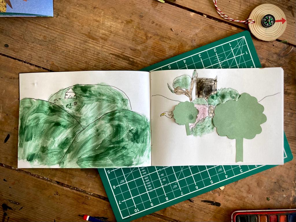 A child's sketchbook with natural imagery.