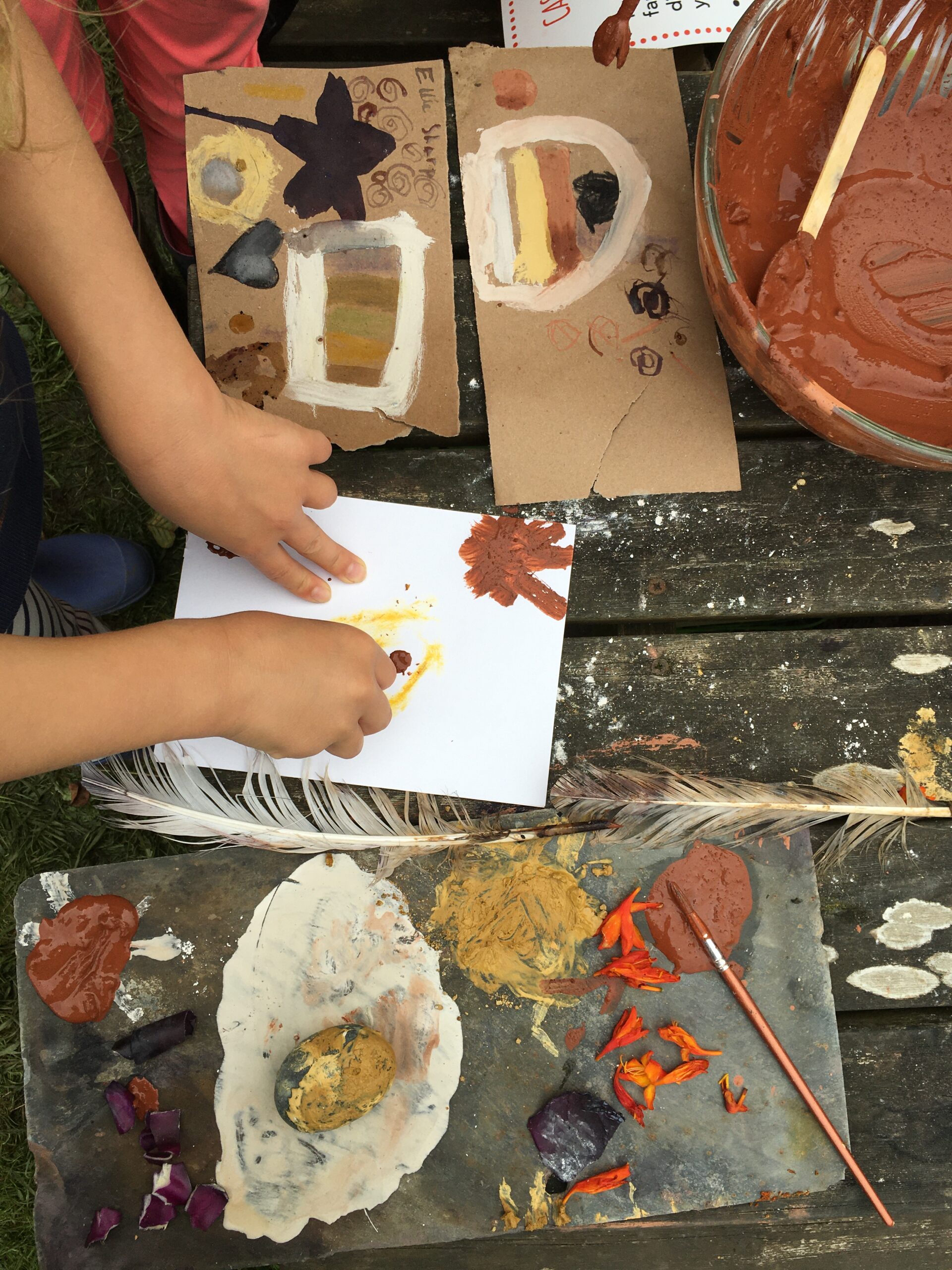 Two hands make a painting from natural materials