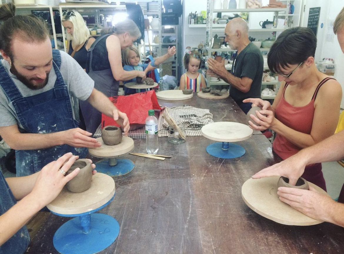 Participants of mixed ages try out clay techniques in the Brickworks workshop in Penryn.