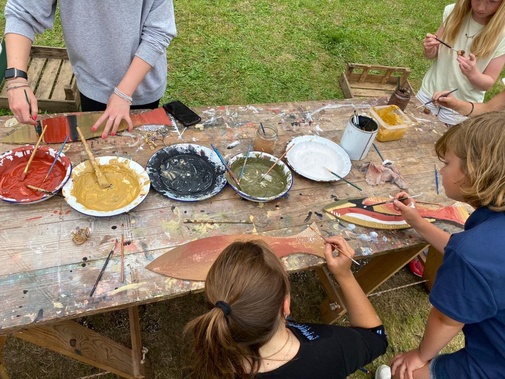 A table with natural pigments. Children painting from these.