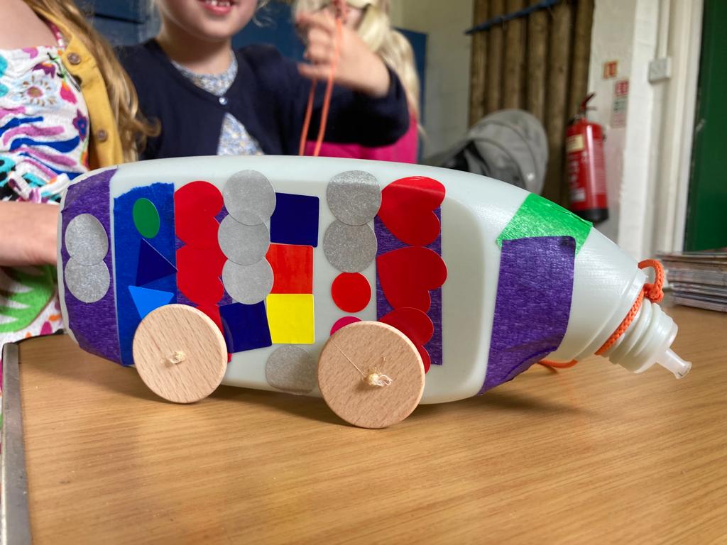 Vehicle made by a child from a plastic bottle
