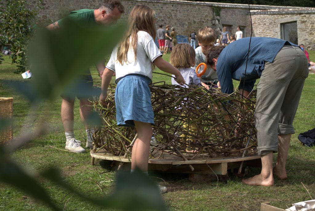 A few people making a large nest