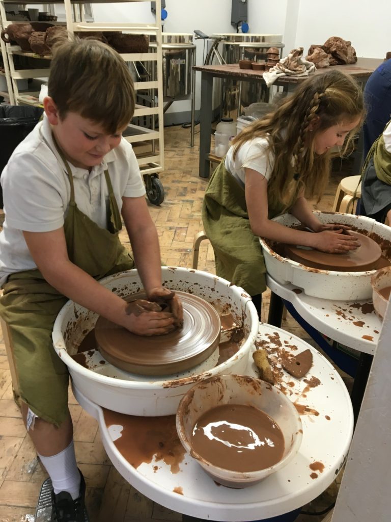 Children use the potter's wheel